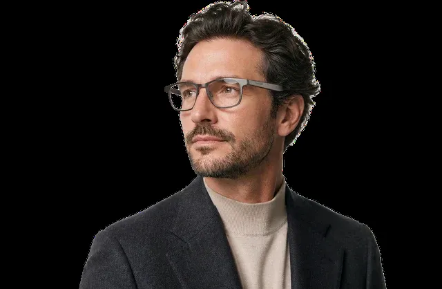 Man wearing glasses and a dark jacket