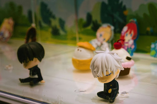 Small collectible character figurines displayed together, representing playful desk decor and personal expression in a modern workspace.