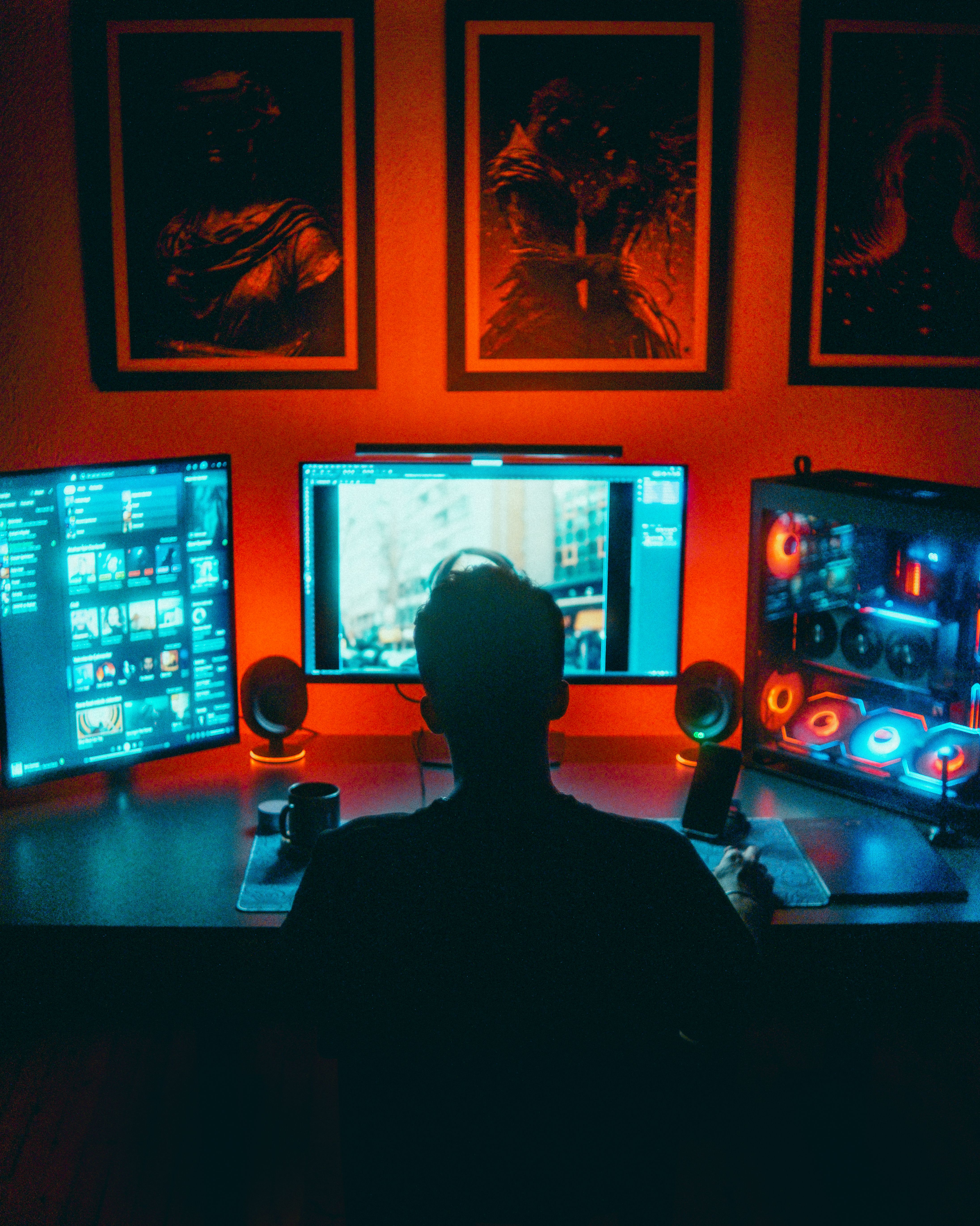 Person gaming at a dual-monitor computer setup
