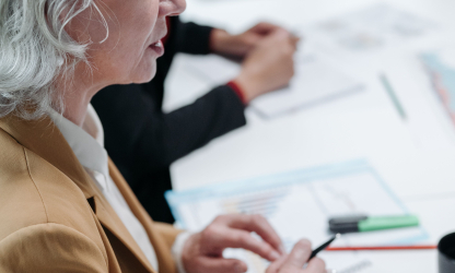 Businesswoman taking notes at a meeting table