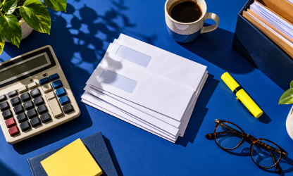 Payroll documents and calculator on a desk