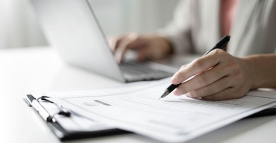 business woman with laptop and resume