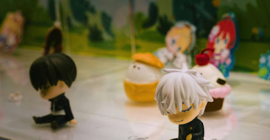 Small collectible character figurines displayed together, representing playful desk decor and personal expression in a modern workspace.