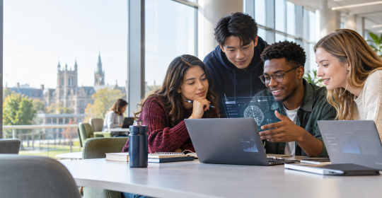 University students collaborating with laptops in a campus study space