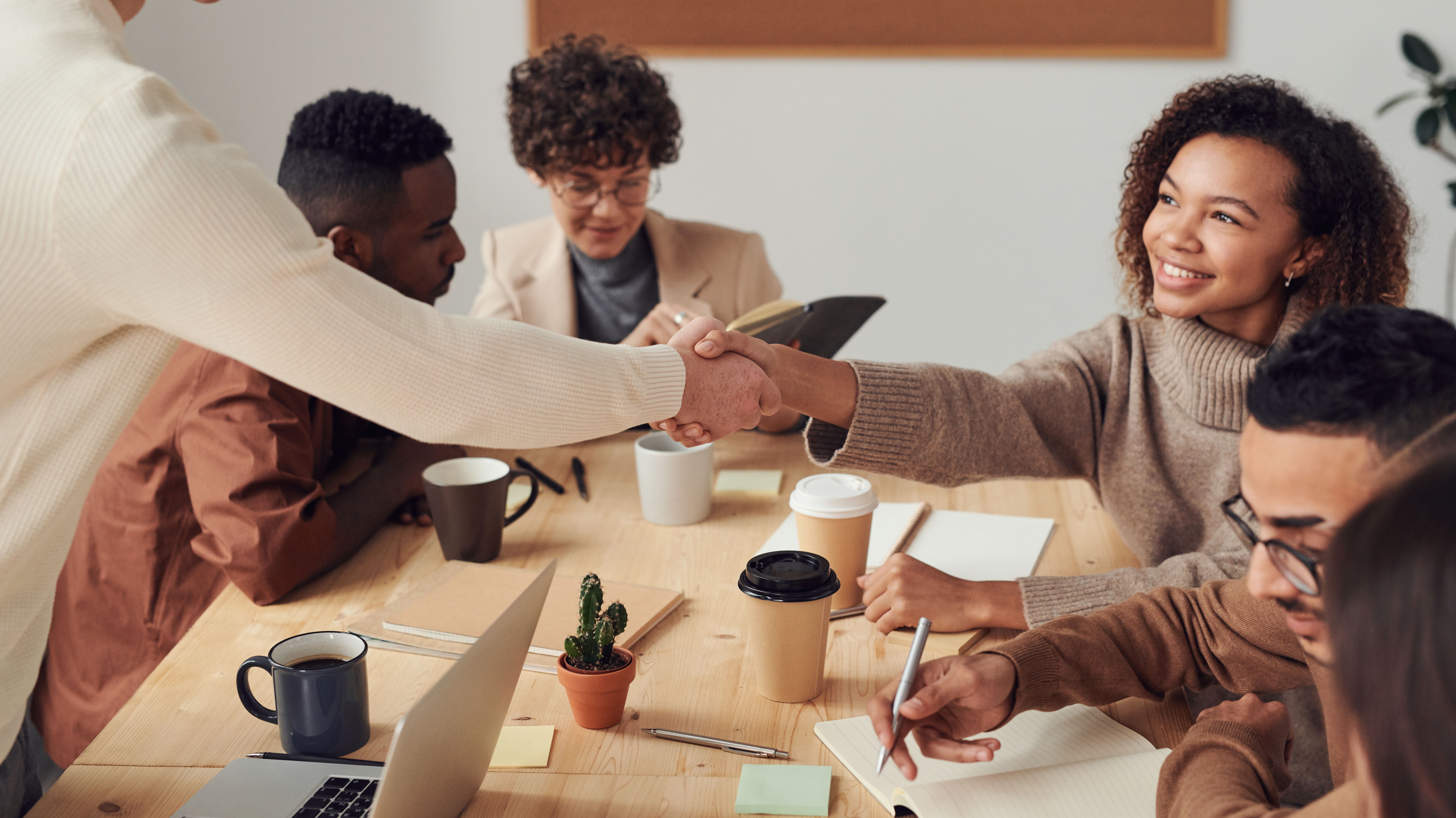 Workplace perks and employee benefits Colleagues collaborating in an office meeting